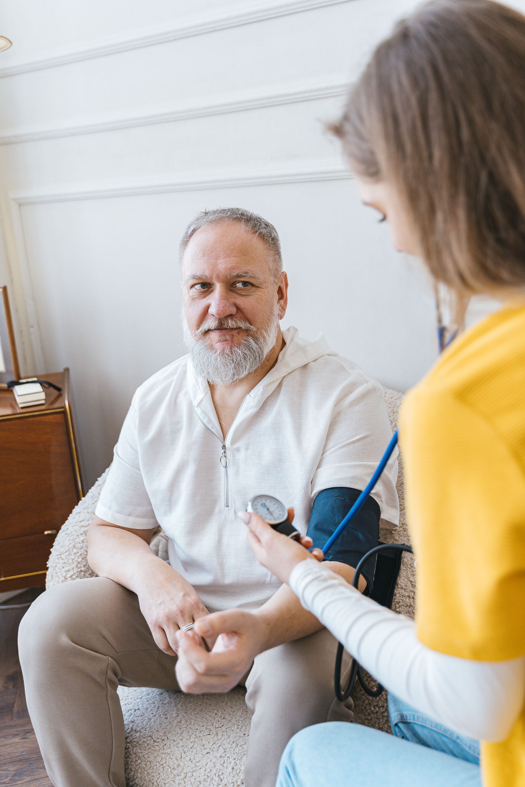 At-home blood-pressure check with a smiling patient