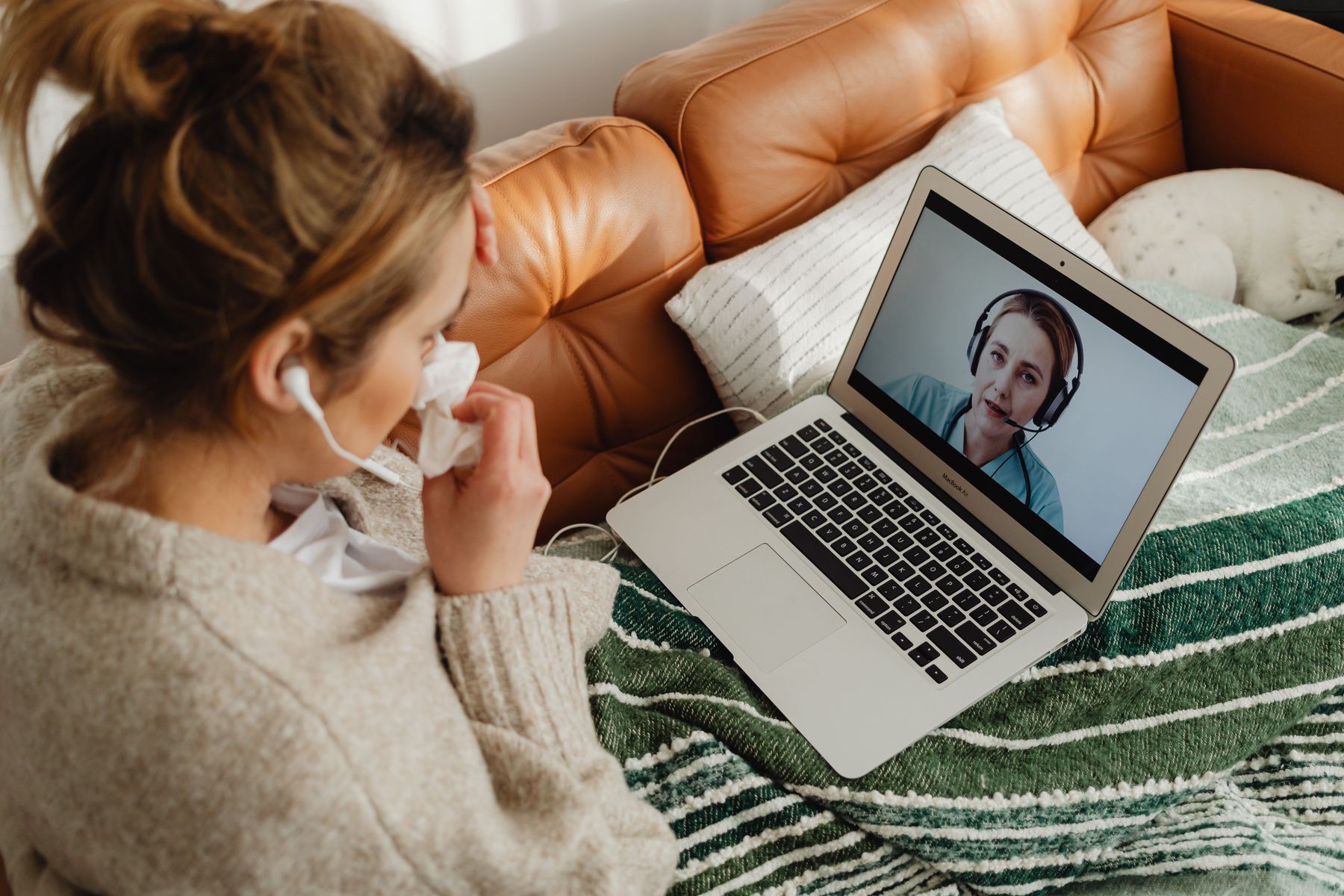 Patient on a telehealth video call from a couch at home